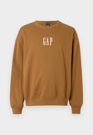 Ruskea huppari, jossa on pyöreä kaula-aukko, ribbireunat hihoissa ja helmassa, sekä valkoisella brodeerattu "GAP" edessä keskellä. Puuvillasekoitetta.