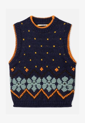 Marineblå strikket ærmeløs vest med orange kant, gule prikker og et mønstret bånd med lyseblå blomster og orange zigzagmønster på forsiden.