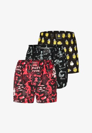 Schwarze Badeshorts mit einem lebhaften roten Muster aus Geistern, Spinnen und Totenköpfen. Elastischer Bund mit verstellbarem Kordelzug, leichtes Material.