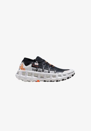 Chaussure de course avec tige en mesh noir et blanc, accents orange et semelle blanche épaisse avec découpes carrées pour l'amorti.