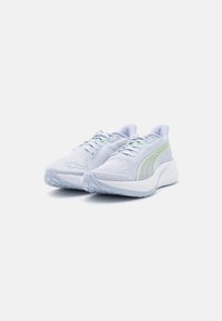 Light blue athletic shoes made of mesh material; features white soles, green accents, textured surface, and a rounded toe design.