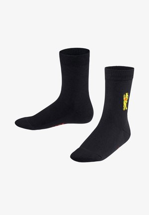 Schwarze Baumwollsocken mit rippenförmigen Bündchen, die auf der Seite eine gelbe animierte Figur und roten Akzenttext in der Nähe der Zehen zeigen.