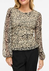 Lendlev õhuline pluus läbipaistvate pikkade varrukatega, beež kangas musta tiigrilõike mustriga. Ümar kaelus ja vöökohal kogutud detailid.