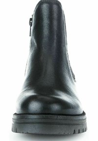 Bottine en cuir noir avec une finition lisse, bout arrondi et semelle en caoutchouc texturée. Fermeture zippée sur le côté et détails de couture minimaux.