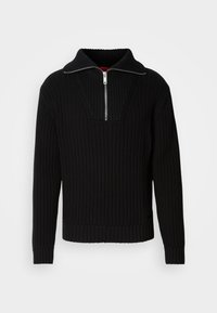 Suéter negro acanalado con un cuello alto y una cremallera corta. Presenta una tela texturizada y puños ajustados, proporcionando una silueta estructurada.