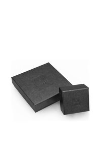 Black gift boxes in varying sizes, one large square and one smaller cube, made of matte cardstock with a debossed logo.