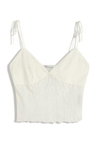 Bílý bezrukávový crop top s tenkými vázacími ramínky, výstřihem do V a jemným květinovým výšivkovým vzorem.