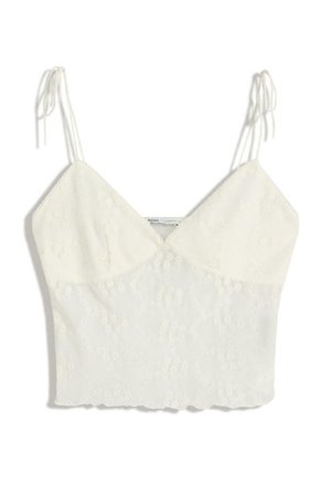 Hvid ærmeløs crop top med tynde bånd, V-udskæring og delikat blomsterbroderi.