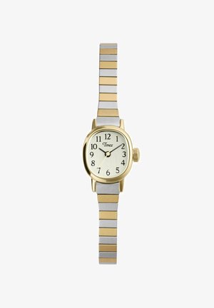 Mažas Timex rankinis laikrodis su auksuoto tono ovaliu ciferblato dėklu, baltu ciferblatu, juodais skaitmenimis ir sidabro bei aukso spalvos kaitaliojamu metaliniu dirželiu.