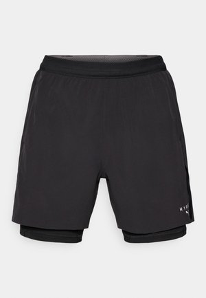Black athletic shorts with a layered design, featuring a smooth outer fabric, elastic waistband, and inner mesh liner. Branding on side.