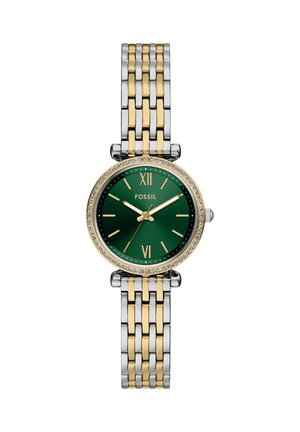 Montre-bracelet Fossil à cadran rond vert avec chiffres romains dorés, lunette ornée de cristaux et bracelet métallique bicolore argent et or.
