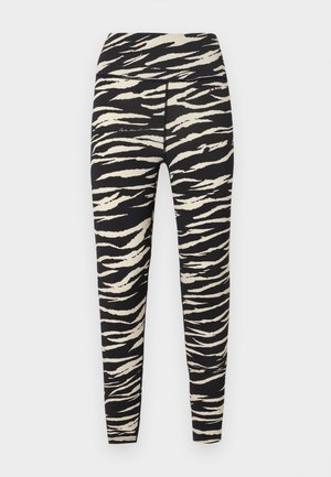 Leggings a fantasia nera e crema con motivo a strisce di tigre, vita alta e tessuto elastico per comfort e flessibilità.