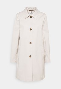 Ljusa beige, lång kappa av slät tyg med spetsig krage, framknäppning och två sidofickor.