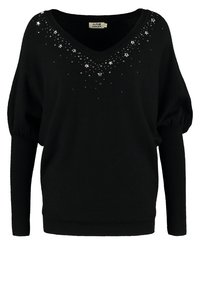 Svart tröja med V-ringning, puffärm och stjärndekorationer vid halsringningen. Mjuk textur, avslappnad passform och ribbade cuffs.