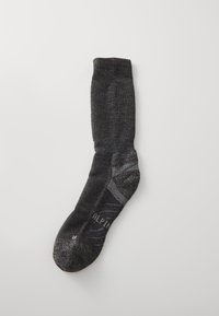 Grijze kniekous met een geribbeld manchet, textuur breiwerk, versterkte teen en subtiele branding. Heeft een contrasterende lichtere band nabij de enkel.