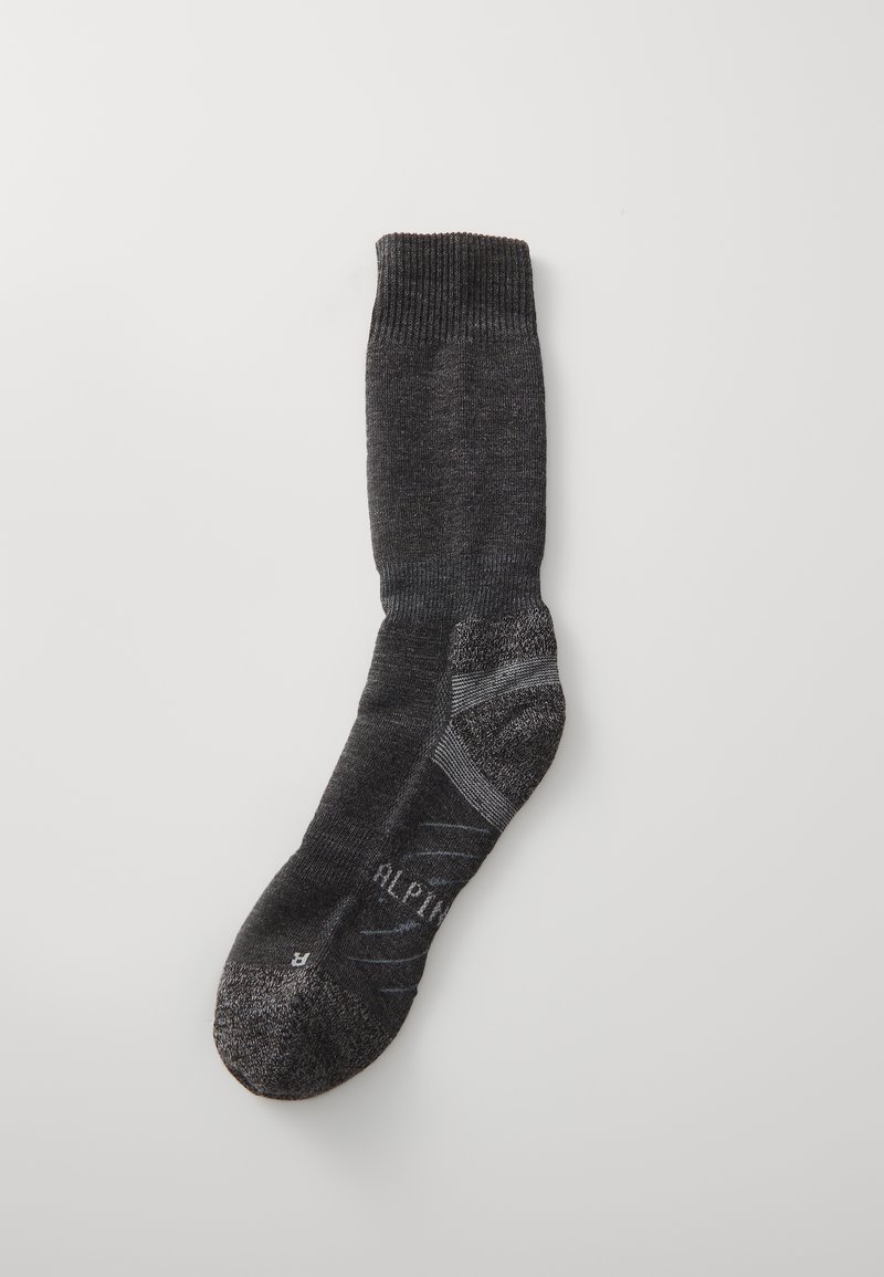 Grijze kniekous met een geribbeld manchet, textuur breiwerk, versterkte teen en subtiele branding. Heeft een contrasterende lichtere band nabij de enkel.
