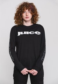 Black long-sleeve t-shirt with "juice" printed prominently on the front in white. "Respect" is printed vertically in white on the sleeve.