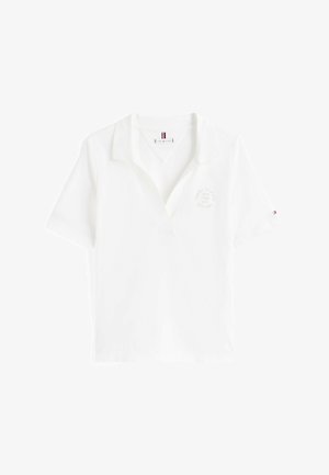 Polo shirt blanc à manches courtes, col, et un logo imprimé subtil sur la poitrine. Matériau en coton avec une texture lisse.
