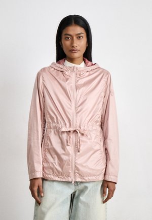 Light pink hooded jacket with a cinched waist, zip closure, and long sleeves. Smooth, shiny fabric with a relaxed fit.
