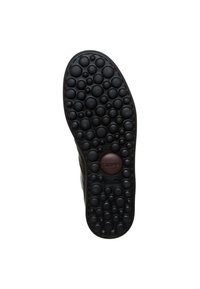 Suela de zapato de goma negra con un patrón texturizado de burbujas, que presenta un disco de logo central y bordes redondeados para mayor agarre y comodidad.