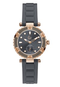 Orologio rotondo con cinturino in silicone grigio, dettagli in oro rosa, quadrante grigio, bezel testurizzato e indicatori e sottoquadro a contrasto. Movimento svizzero di qualità.