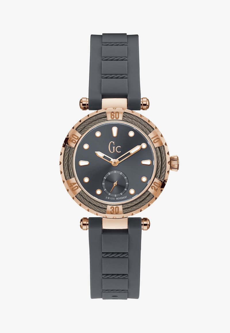 Orologio rotondo con cinturino in silicone grigio, dettagli in oro rosa, quadrante grigio, bezel testurizzato e indicatori e sottoquadro a contrasto. Movimento svizzero di qualità.