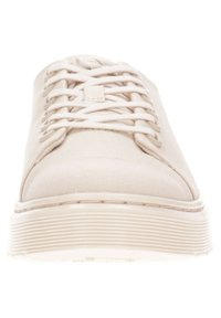 Beige canvas sneaker with a rounded toe, flat lace-up design, and a textured white rubber sole featuring horizontal stripes.