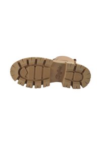 Semelle de botte en caoutchouc beige avec un motif de bande de roulement profond, présentant de nombreuses rainures et crevasses pour une adhérence optimale, logo en relief près du talon.
