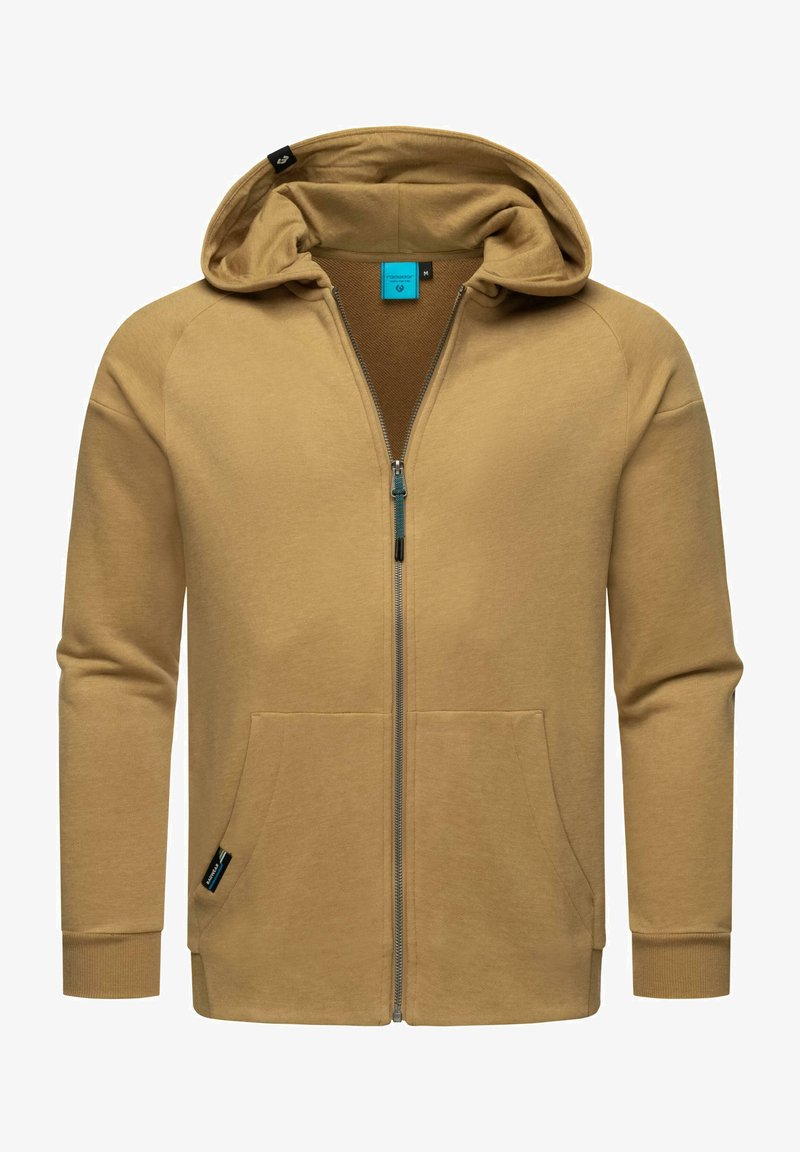 Felpa con zip di colore beige realizzata in materiale morbido, dotata di cappuccio, due tasche frontali e polsini a coste. All'interno presenta una fodera marrone a contrasto.