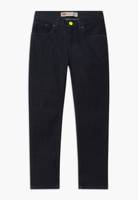 Dark denim jeans with a slim fit, featuring front pockets, metal hardware, and a bright yellow button on the waistband. Classic five-pocket design.