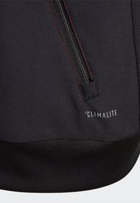 Black athletic jacket featuring a smooth fabric texture, red stitching accents, side zipper, and a "CLIMALITE" label.