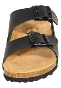 Black two-strap sandal with buckles, cork footbed, textured brown insole, and black rubber sole. Clean design with adjustable straps.