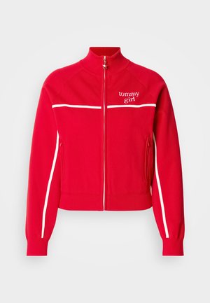 Red zip-up jacket made of soft fabric. Features white stripes along the shoulders and side seams, with "tommy girl" logo at chest. Stand collar.