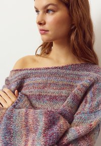 Multicolored knitted sweater featuring a loose fit, off-shoulder design, and a textured pattern with shades of purple, blue, and pink.
