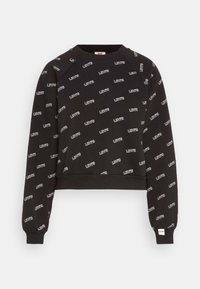 Felpa nera corta con un motivo ripetuto di logo "Levi's" bianco, maniche raglan e polsini e orlo a costine. Tessuto morbido in mix di cotone.