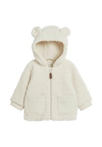 Hvid faux fur jakke med bjørneører på hætten, frontlynlås, to påsyede lommer og ribbede manchetter. Blød tekstur, hyggeligt design.