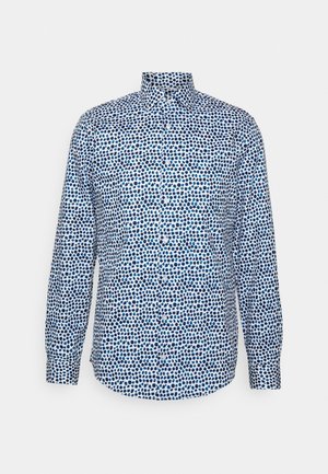 Long-sleeve button-up shirt with white base and irregular dark and light blue polka dot pattern, classic collar, and buttoned cuffs.