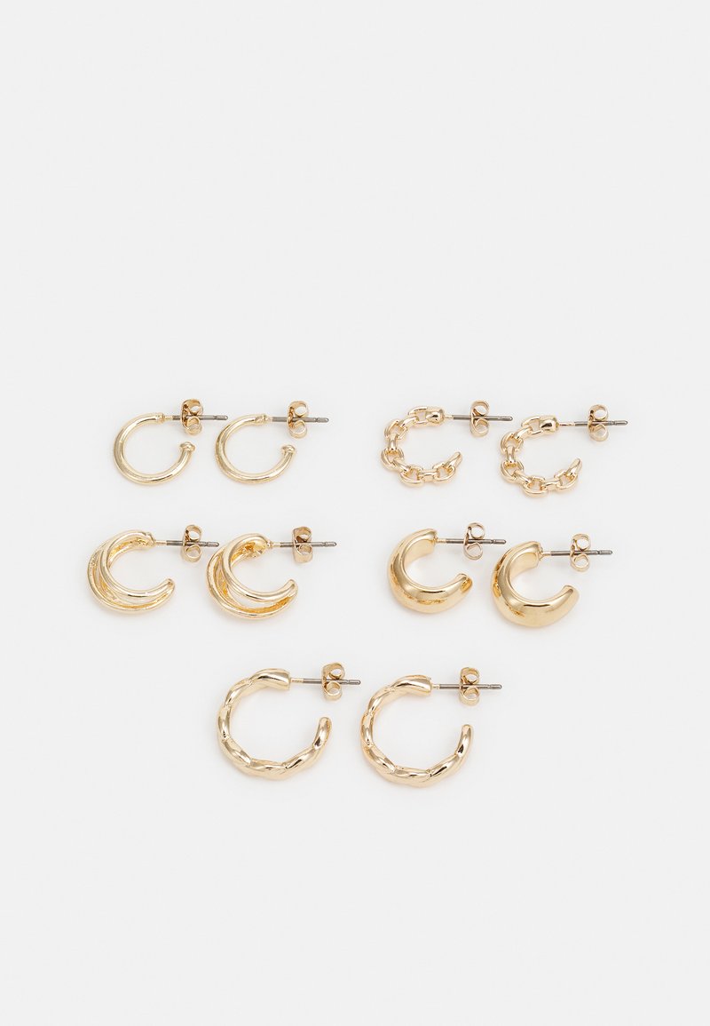 Gold-colored earrings set, featuring different shapes: small hoops, chunky crescents, and chain accents. Smooth and textured finishes.