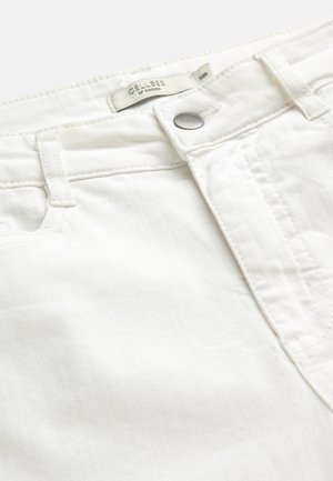 White denim jeans waistband with metal button, belt loops, and visible Cellbes of Sweden size 38R tag.