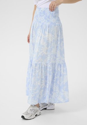 Light blue maxi skirt with smocked waist, paisley pattern, tiered design, and soft fabric. Paired with gray sneakers.