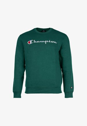 Sudadera verde hecha de una tela suave. Presenta el logo gris "Champion" en el pecho y un parche del logo en la manga izquierda. Cuello redondo.