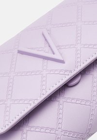 Purple leather clutch with geometric embossed pattern, featuring a prominent V-shaped accent and a snap closure.