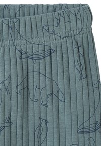 Blue ribbed fabric with navy line drawings of polar bears, whales, and penguins, featuring an elastic waistband.