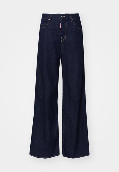 Wide-leg dark blue denim jeans with a high waist, featuring golden stitching and front pockets. Iconic red label on the waistband.