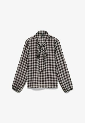 Langermet bluse med svart-hvitt rutemønster, pyntet med sløyfe rundt halsen og elastiske mansjetter, på hvit bakgrunn.