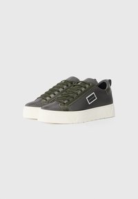 Athletic sneakers in dark green and gray with a textured mesh upper, round toe, thick white sole, and a small logo detail on the side.