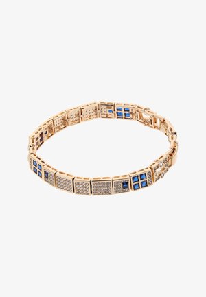Bransoletka w odcieniu złotym z prostokątnymi ogniwami ozdobionymi niebieskimi i przezroczystymi kamieniami szlachetnymi, na przemian z różnymi fakturami oraz z zamknięciem na klik.