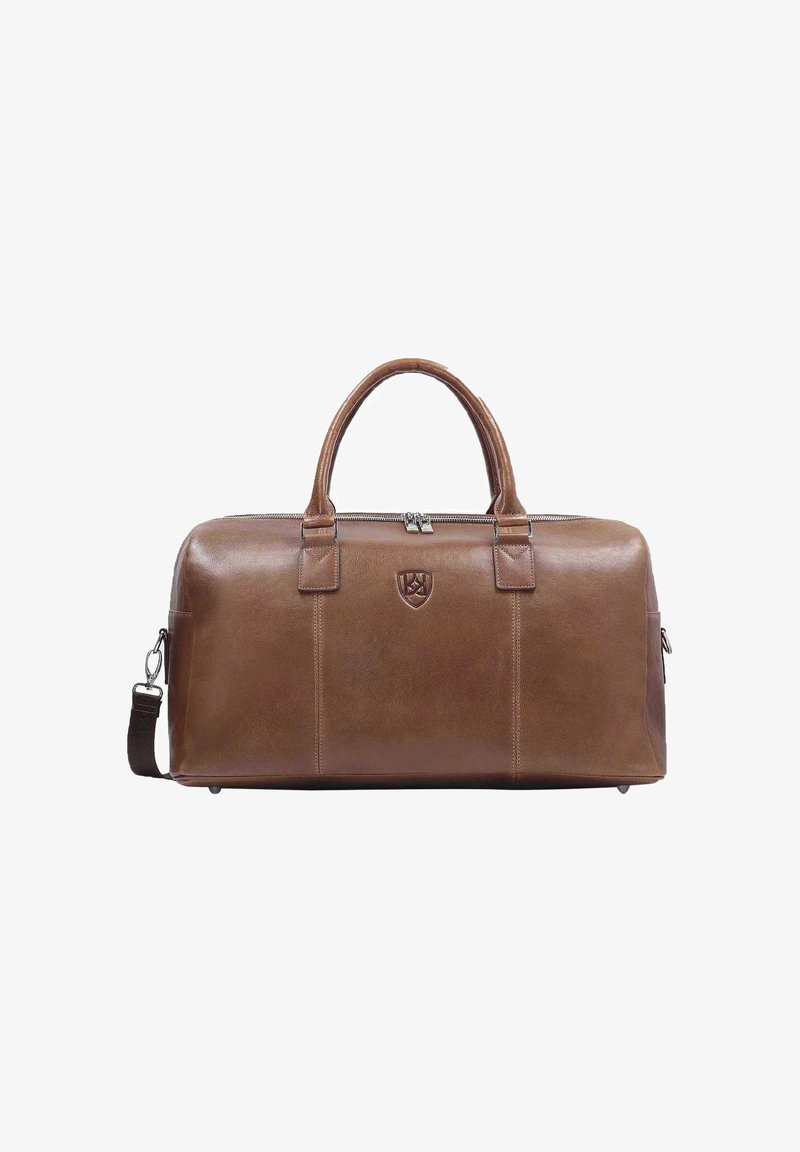 Ruskea nahkainen viikonloppulaukku pyöreillä kahvoilla, vetoketjulla ja olkahihnalla. Varustettu logolla, suorakulmainen ja sileä pinnaltaan.