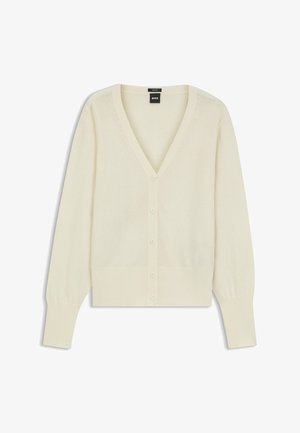 Kardigan w kolorze kremowym z dekoltem w serek, zapinany na guziki, z długimi rękawami. Wykonany z miękkiego materiału z prążkowanymi detalami na mankietach i dolnej krawędzi.