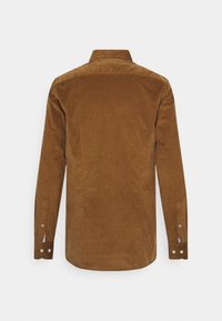 Bruine corduroy blouse met lange mouwen, manchetten met knopen en een klassieke kraag. Gestructureerde stof en een afgeronde zoom.